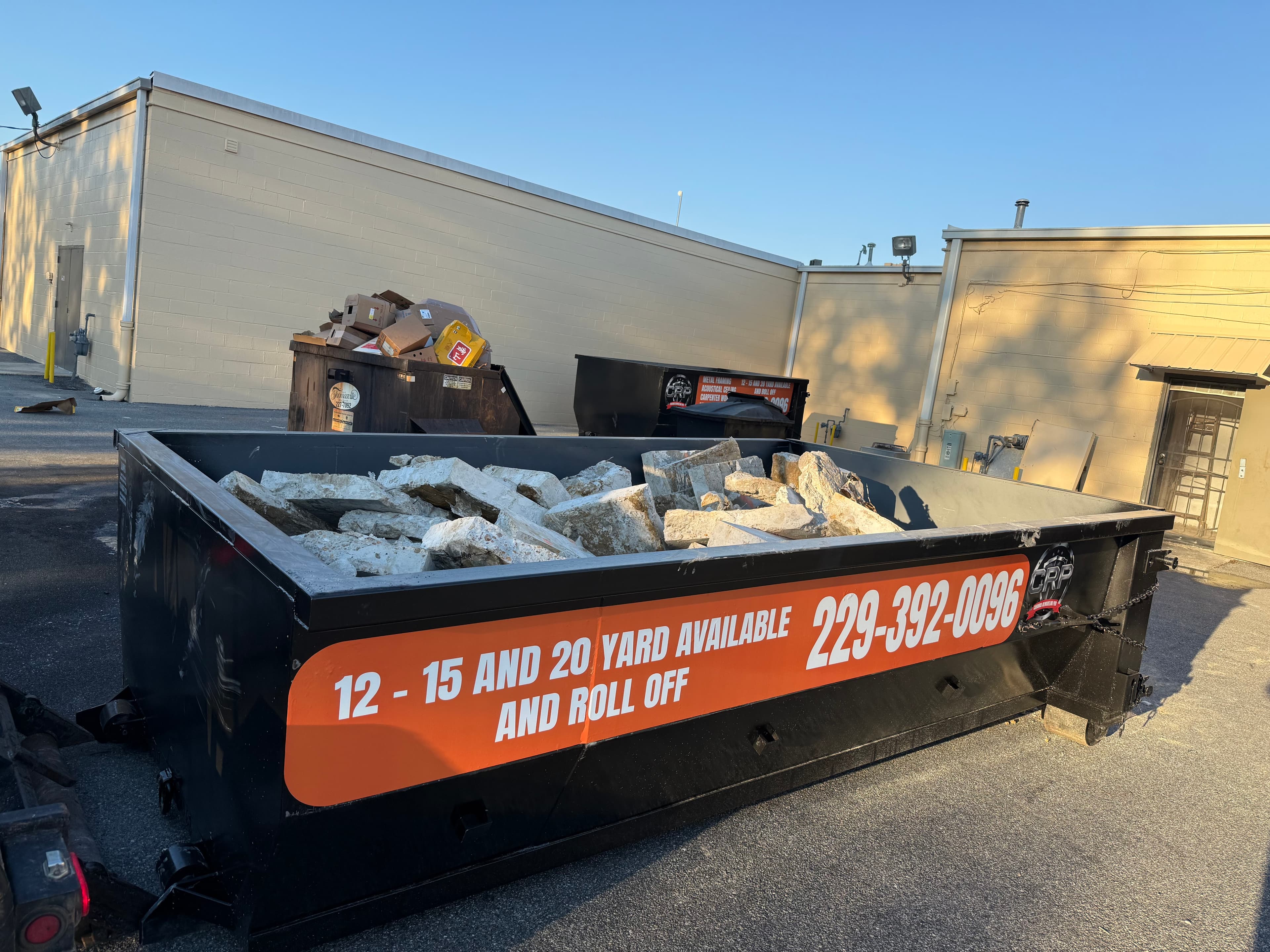 CRP dumpster rental container on a project site